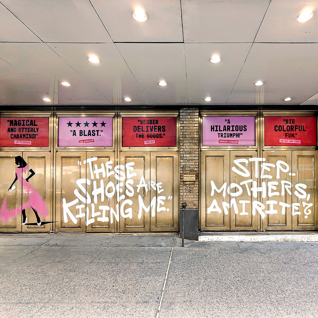 Theater façade decorated with painted quotes promoting the musical Bad Cinderella.